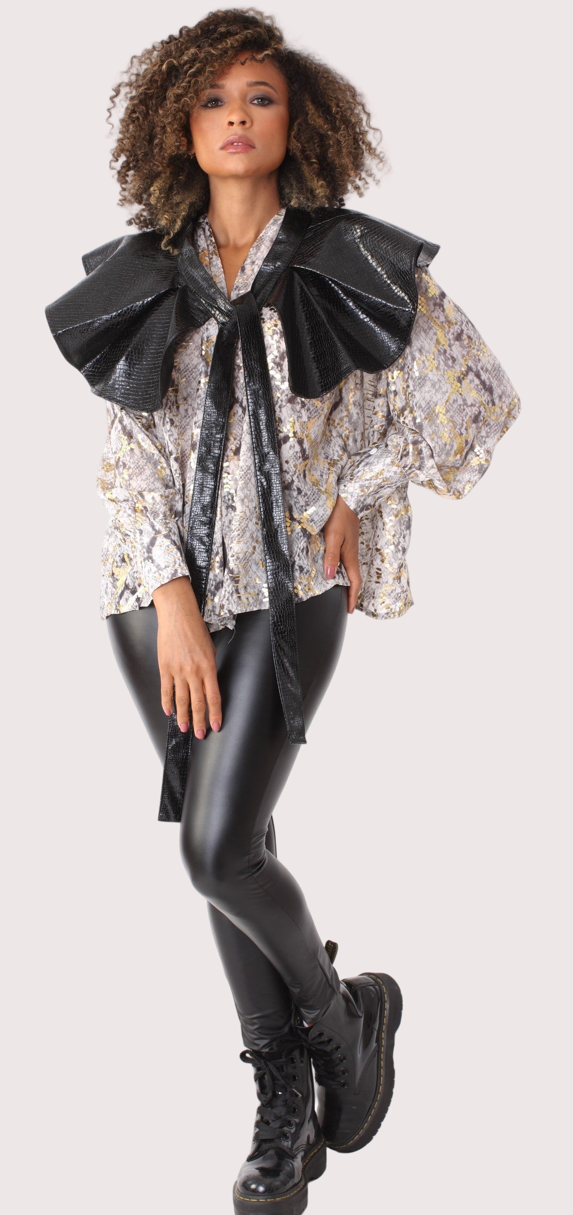 Convertible blouse shown styled with oversized leather bow sleeve.