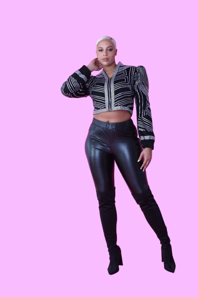 Black cropped jacket with rhinestone detailing shown in a front pose with dynamic stance, emphasizing the geometric rhinestone pattern and modern cropped length by For Her NYC