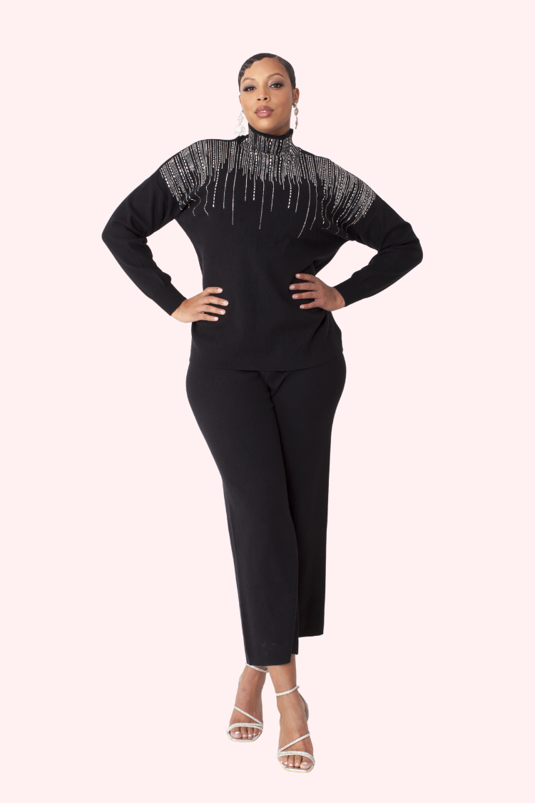 Model wearing the black crystal rain lounge set standing front facing, showcasing long sleeve top with crystal neckline detail and relaxed wide leg pants by For Her NYC
