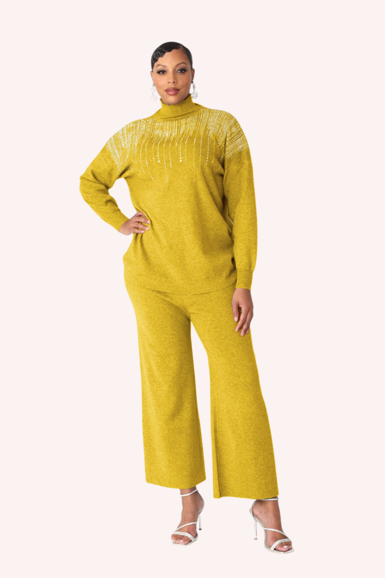 Model wearing the mustard crystal rain lounge set standing front facing, showcasing statement crystal neckline and coordinated wide leg pants by For Her NYC
