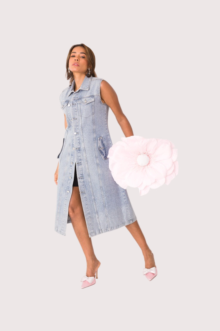 Sleeveless denim dress shown in front pose holding a white bag highlighting versatile styling and casual chic appeal, For Her NYC