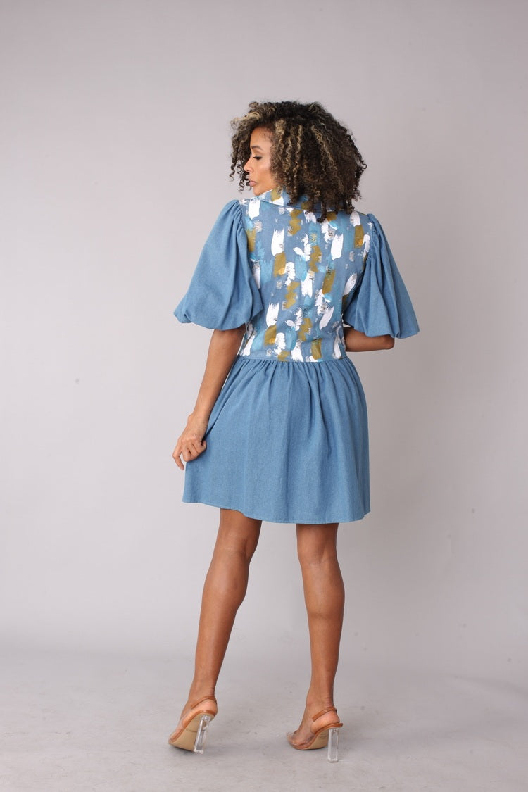 Denim blue puff sleeve dress shown from the back, showcasing the clean back silhouette and skirt flare, versatile casual dress by For Her NYC
