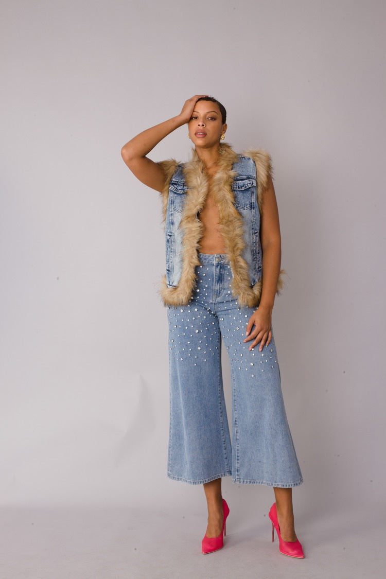 Denim vest with faux fur trim styled in playful front pose highlighting texture contrast and modern layering by For Her NYC