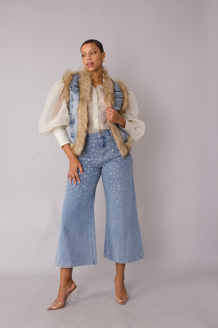 Denim vest with faux fur trim shown in relaxed standing pose emphasizing sleeveless design and luxe trim detail by For Her NYC