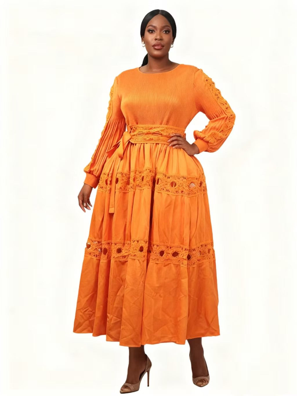 Front view of model wearing an orange long sleeve tiered midi dress with lace trim and soft pleating, For Her NYC