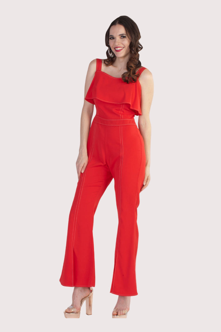 Red flare leg jumpsuit with statement wide leg, front view.