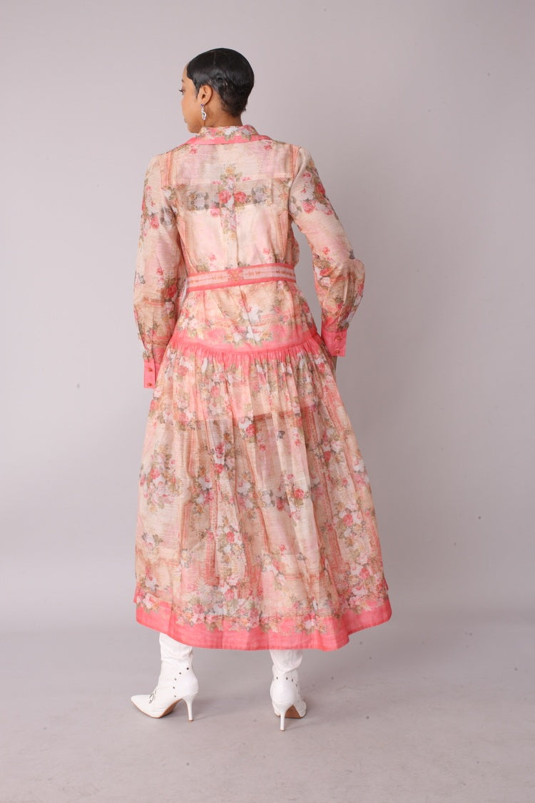 Back view of pink floral shirt dress — long sleeve collared maxi dress with self tie belt showing rear silhouette.