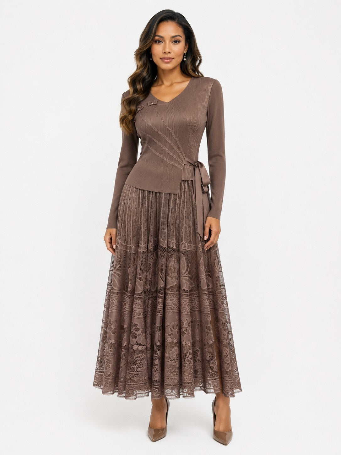 Front view of a model wearing the coffee For Her NYC Belted Lace Pleated Midi Dress - 83465 with long sleeves, a V-neckline, side-tie belt, and floral lace skirt