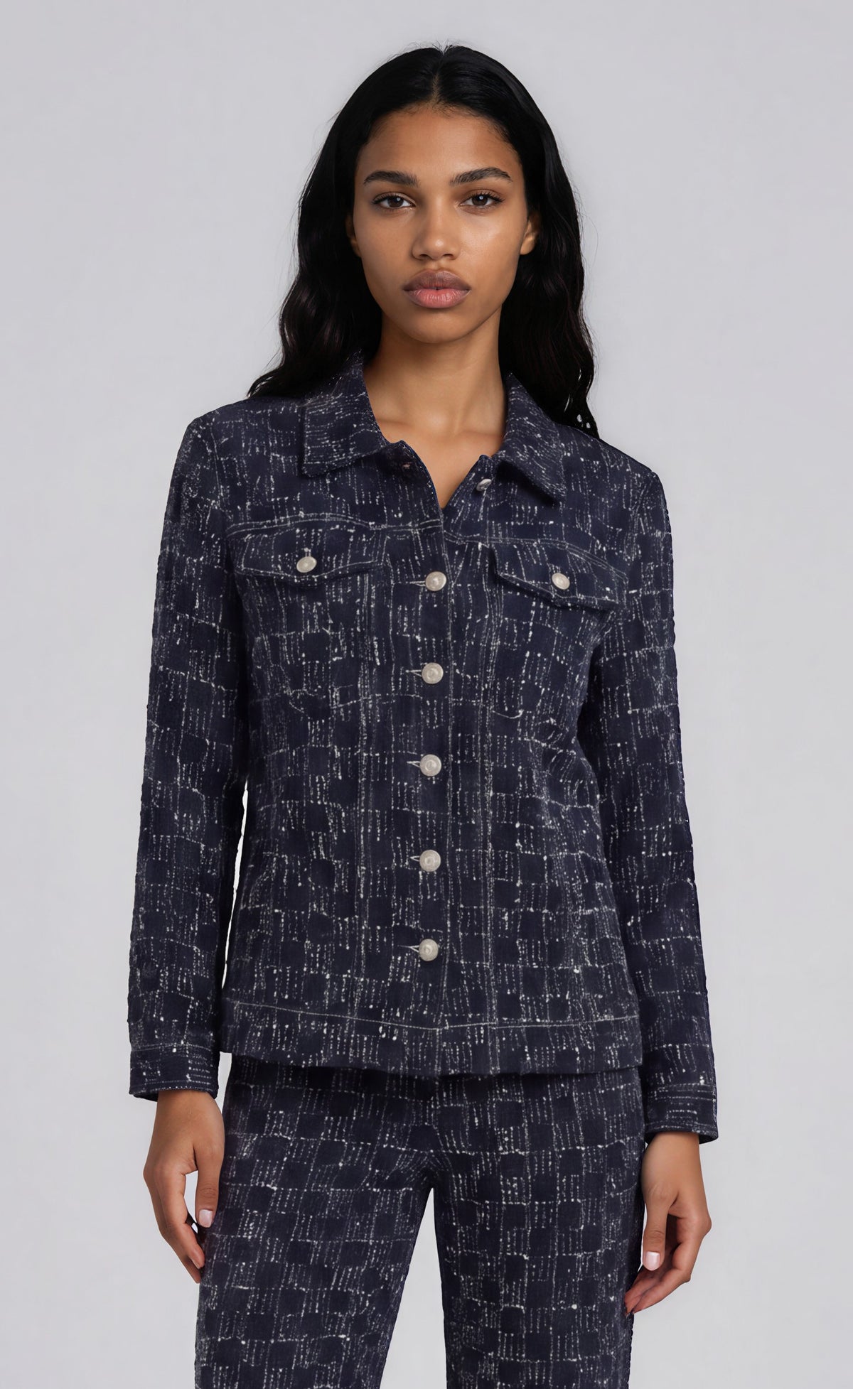 Front view of a model wearing the For Her NYC Dark Wash Textured Denim Jacket - 83380 with silver buttons and flap chest pockets