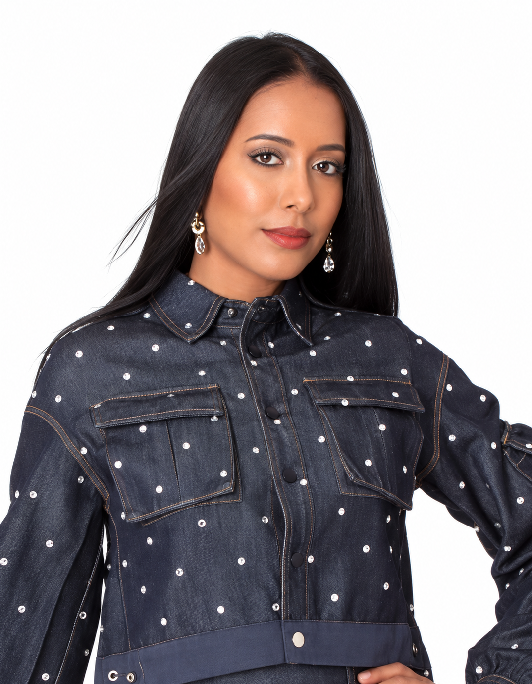 Close front view of a model wearing the dark-wash For Her NYC Embellished Cropped Denim Jacket - 82962 with allover gem embellishments and chest pockets