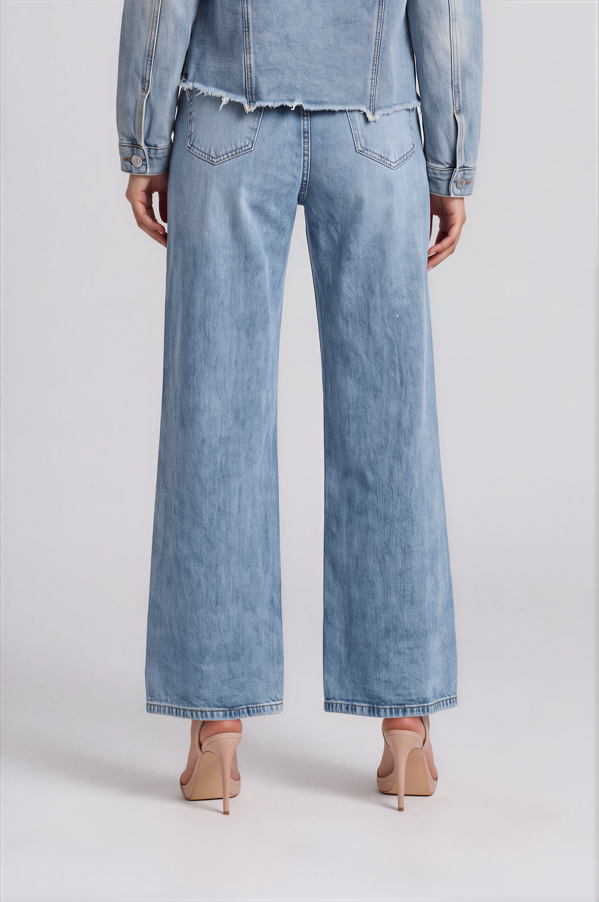 Back detail of a model wearing the denim-color For Her NYC Pearl Wide-Leg Denim Pants - 82776, highlighting the back pockets and wide-leg silhouette