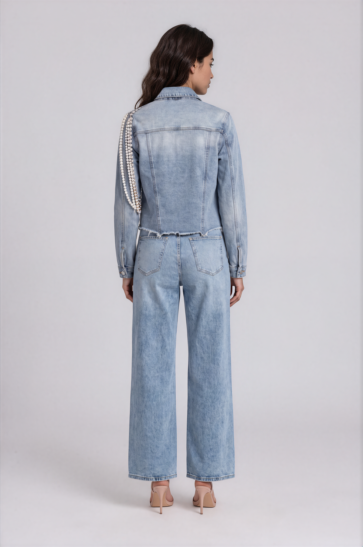 Back view of a model wearing the denim-color For Her NYC Pearl Wide-Leg Denim Pants - 82776 with back pockets and wide legs