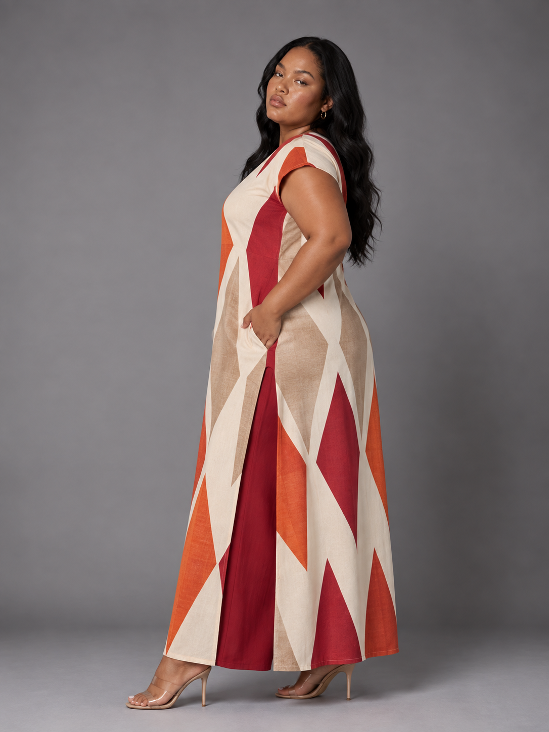 Side view of the For Her NYC Plus Size Bisa Print Pantset featuring a cream, orange, red and beige geometric print tunic with coordinating pants, style S0178.