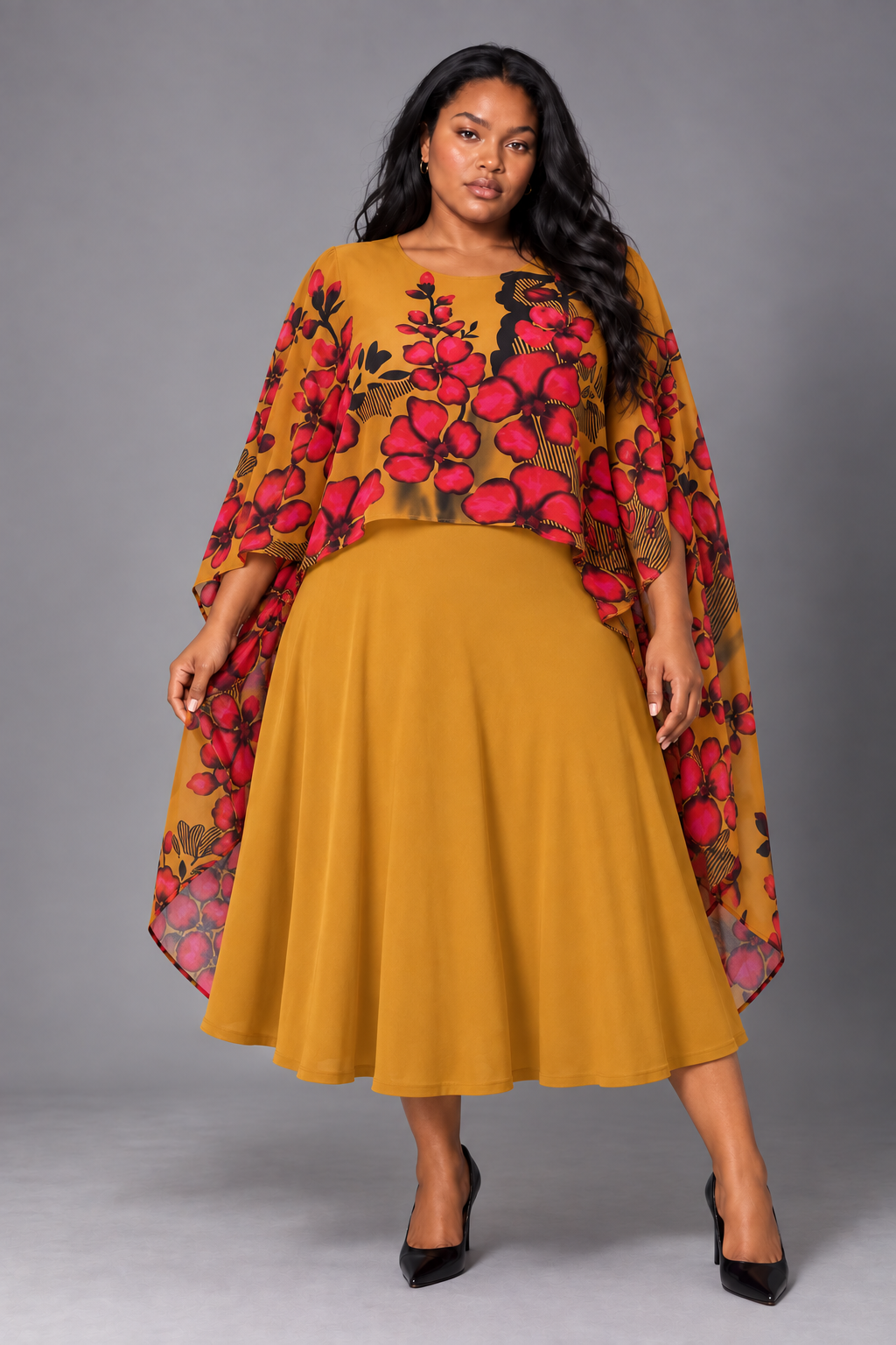 Front view of a plus-size model wearing the For Her NYC Plus Size Floral Cape Overlay Midi Dress - S0280W in mustard yellow with a red and black floral print cape overlay