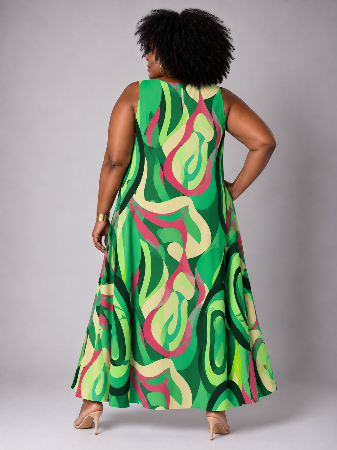 Back view of a model wearing the For Her NYC Plus Size Oversized Swirls Print Maxi Dress with a vibrant green multicolor abstract swirl print, style S0177W.