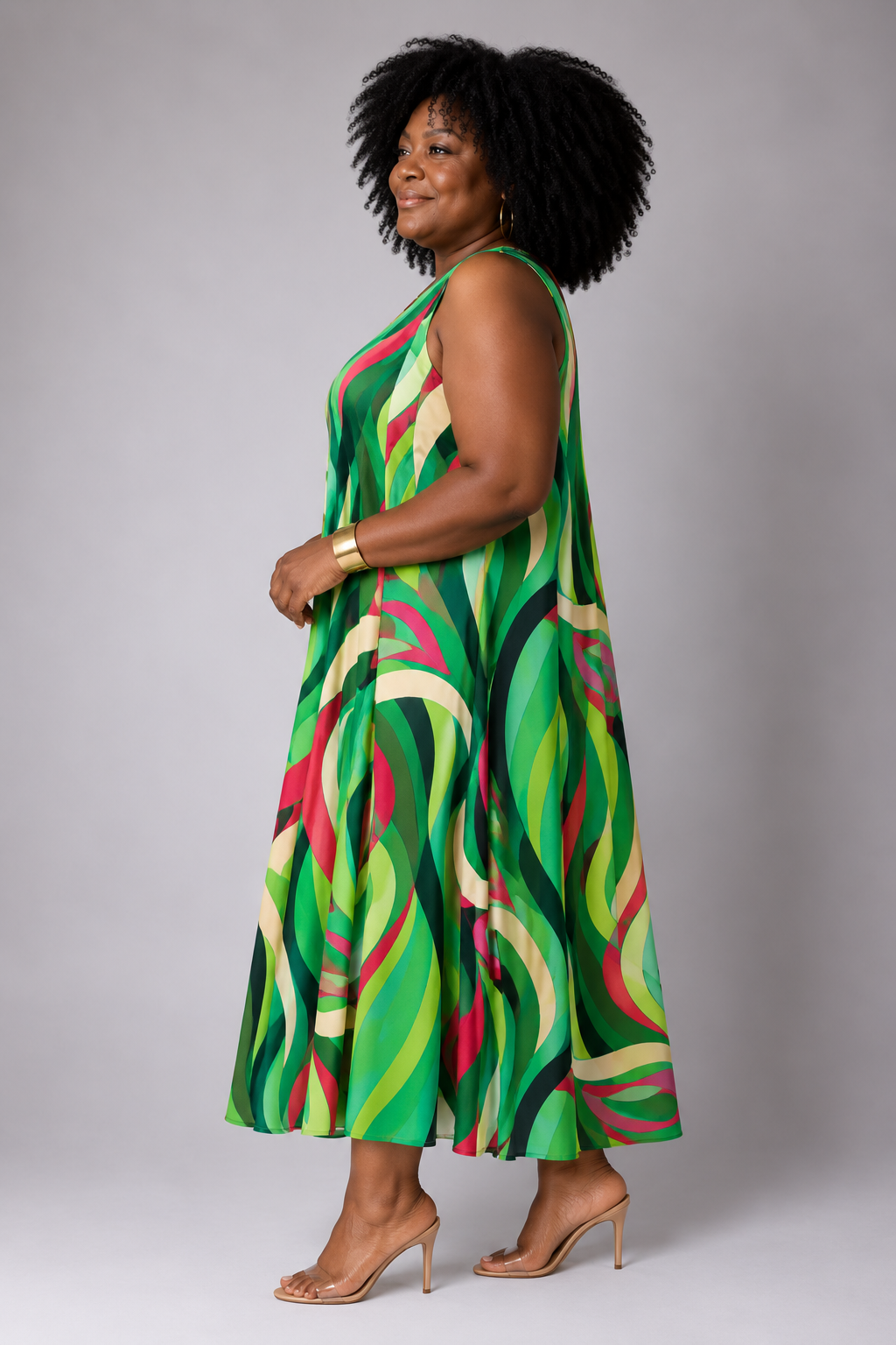 Side view of a model wearing the For Her NYC Plus Size Oversized Swirls Print Maxi Dress with a vibrant green multicolor abstract swirl print, style S0177W.