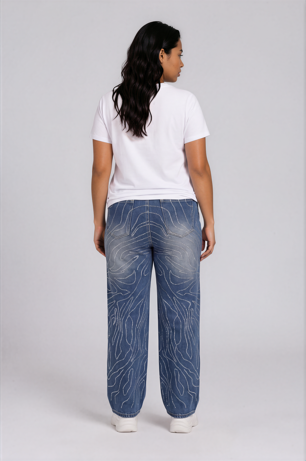 Back detail view of a plus-size model wearing the For Her NYC Rhinestone Swirl Wide-Leg Denim Jeans - 83071 with allover rhinestone detailing