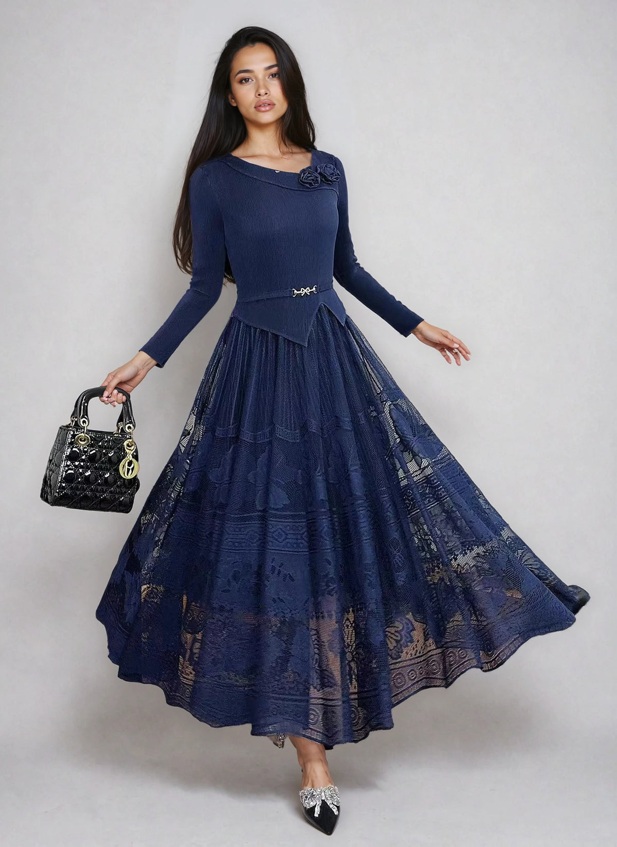 Model wearing navy pleated lace midi dress with floral lace detail, fitted waist, and flared skirt by For Her NYC.