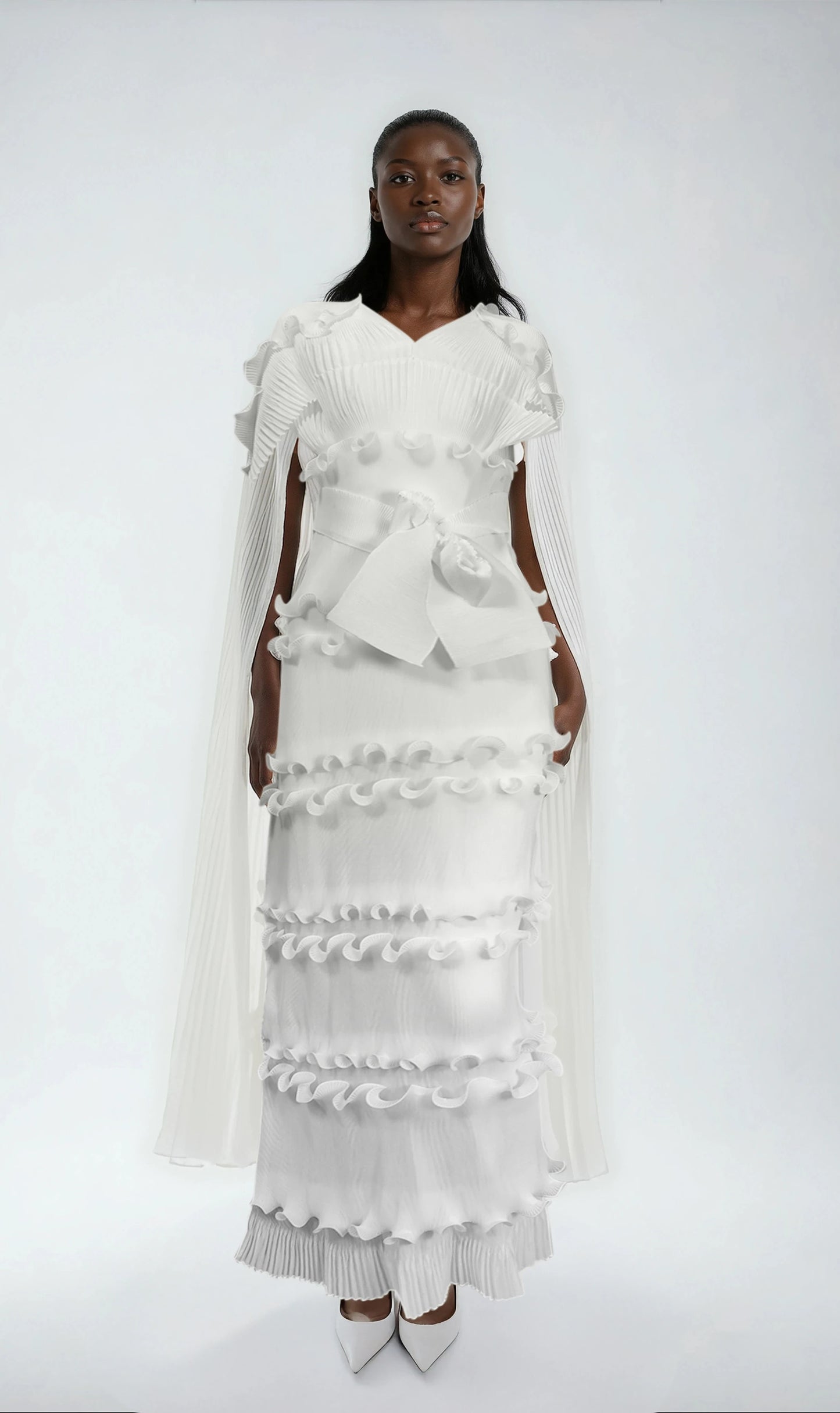 Model wearing white ruffled pleated maxi dress with matching scarf and waist tie by For Her NYC.