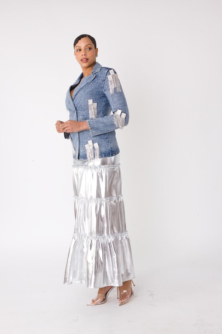 Model wearing the fringe-cropped-denim_jacket with silver metallic tiered maxi skirt standing front facing, showcasing lustrous finish and dramatic tiered silhouette by For Her NYC