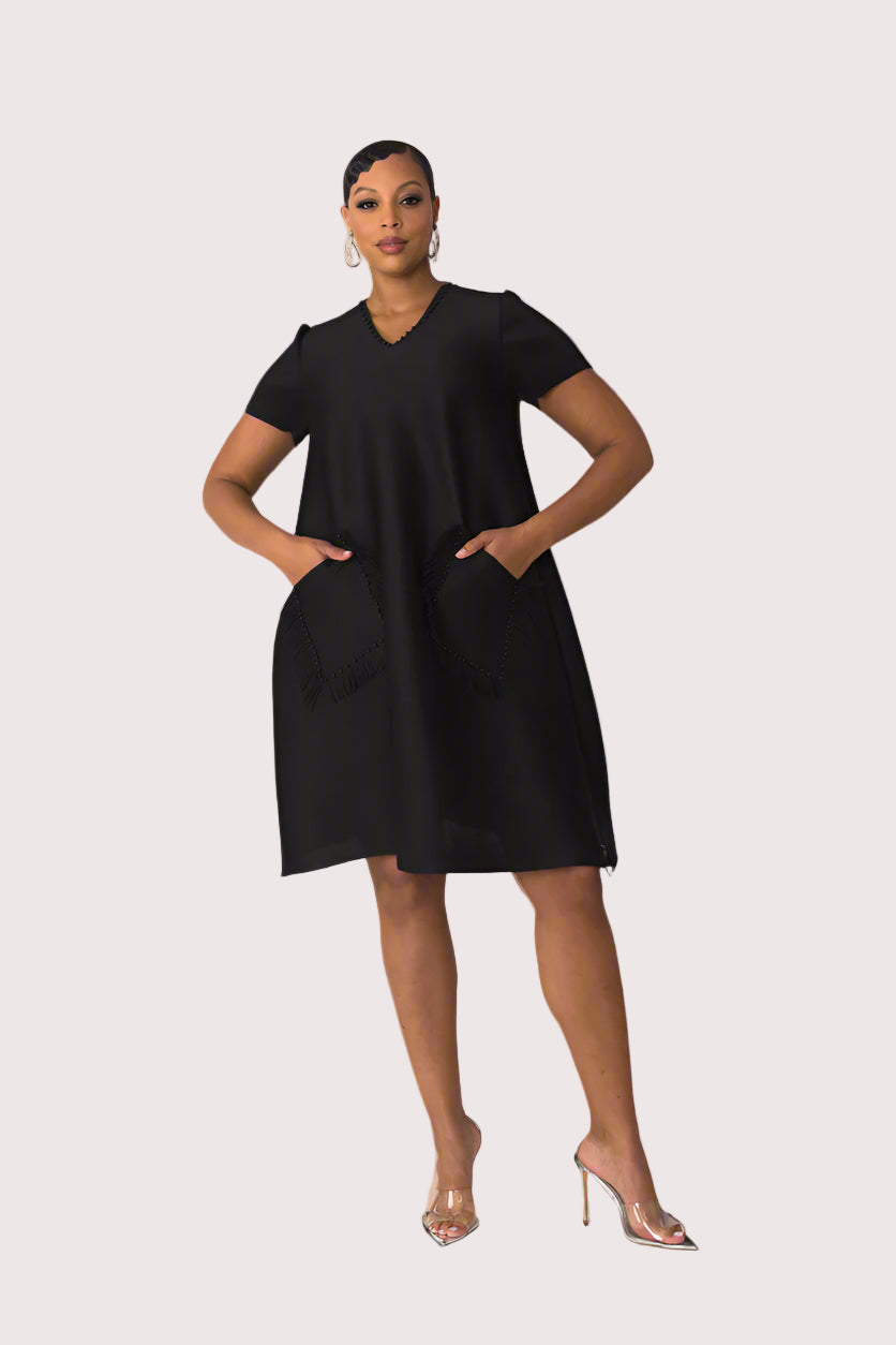 Model wearing the black fringe pocket shift dress standing front facing with hands on hips, featuring studded trim and relaxed silhouette by For Her NYC