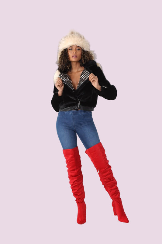 Black faux fur jacket with studded lapel shown in a front full-length pose, featuring a plush faux fur texture, zip-up closure, and bold stud detailing for an edgy statement look by For Her NYC