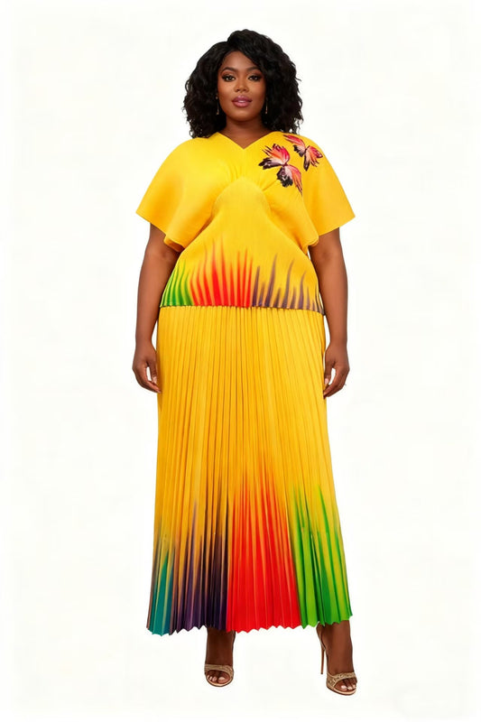 Front view of model wearing a yellow multi gradient pleated skirt set with relaxed top and flowing midi skirt, For Her NYC