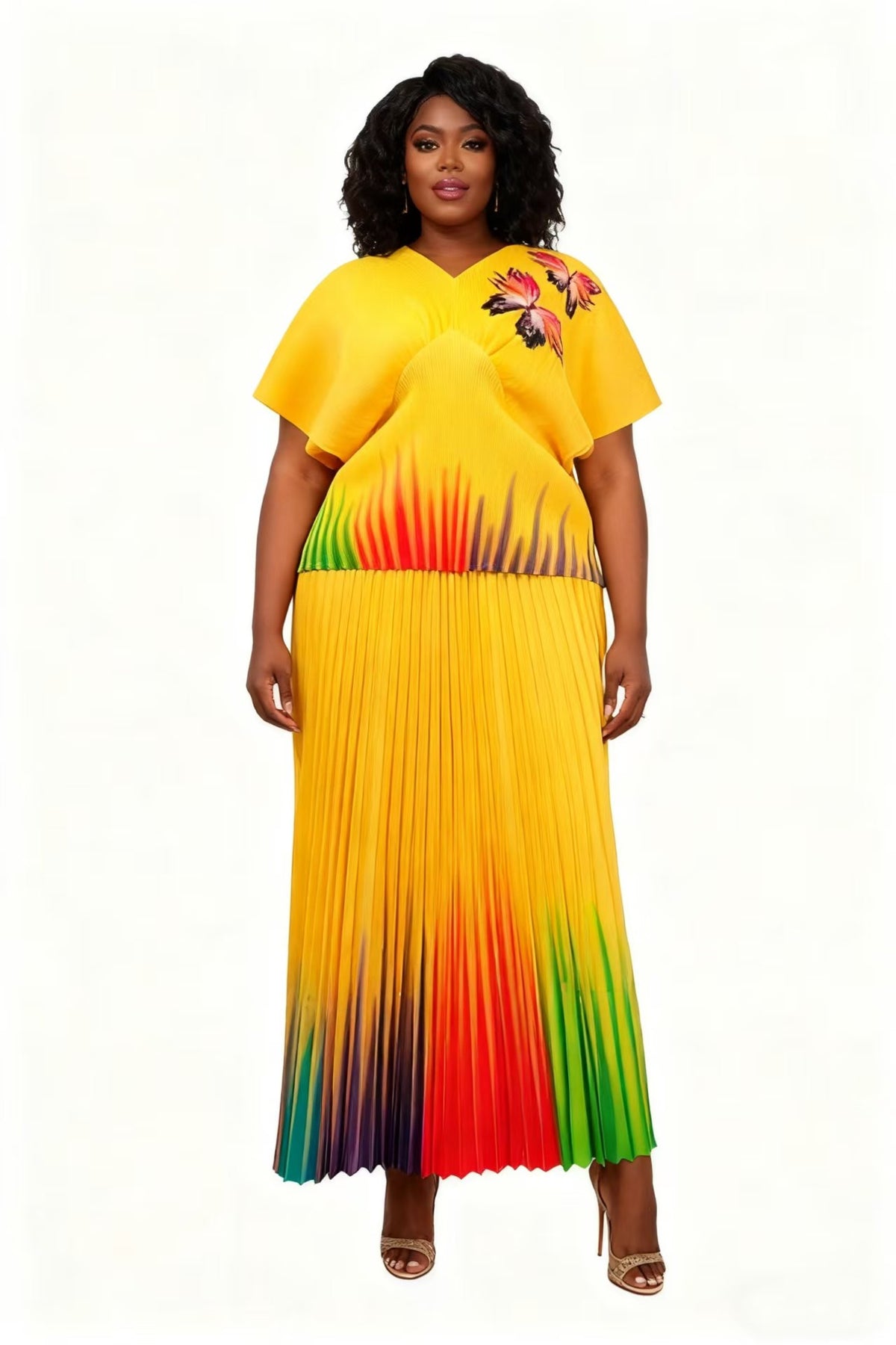 Full-length view of model wearing a yellow multi gradient pleated two-piece skirt set with flowing movement, For Her NYC