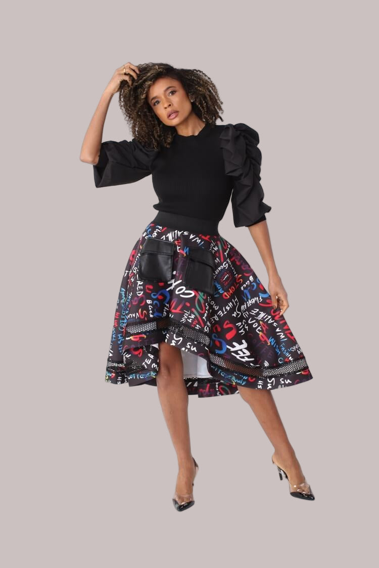 Front full view of graphic scuba skirt with bold print, black netting accent along the high-low hemline, and elastic waistband by For Her NYC