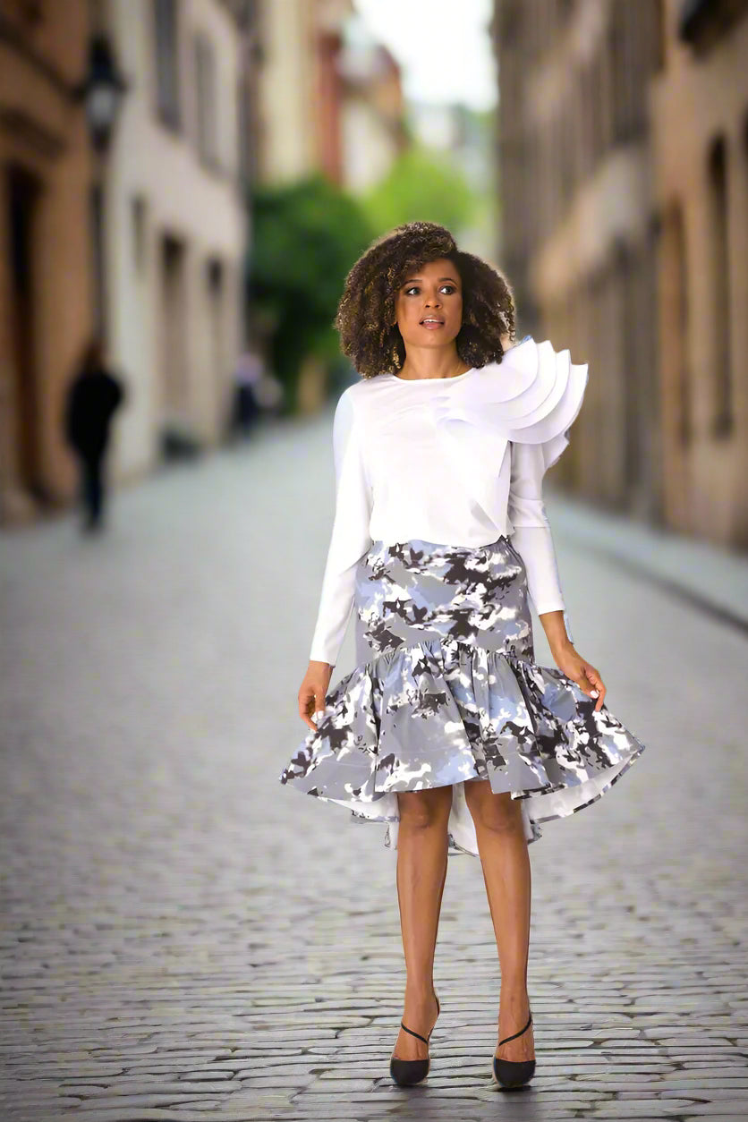 Model wearing grey multi ruffle midi skirt, front-facing hero pose highlighting mixed print and layered ruffle hem by For Her NYC