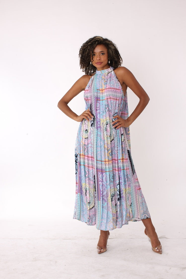 Front view with model hands on hips showcasing movement and shape of pastel patchwork halter maxi dress – For Her NYC