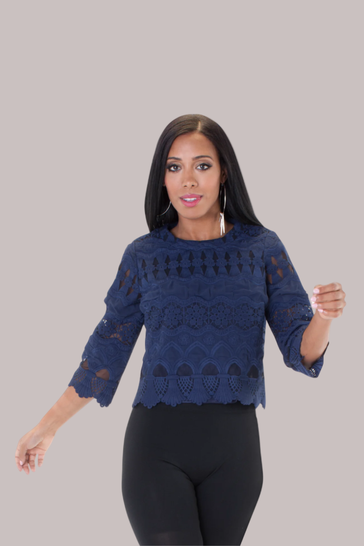 Model wearing navy lace detailed blouse with three-quarter sleeves, front view.