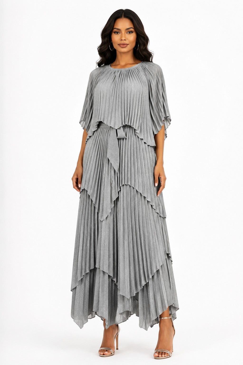 Model wearing the Layered Pleated Maxi Dress with Cape in Silver featuring cascading tiered pleats, a graceful cape overlay, flutter sleeves, and a flowing maxi silhouette by  ForHerNYC