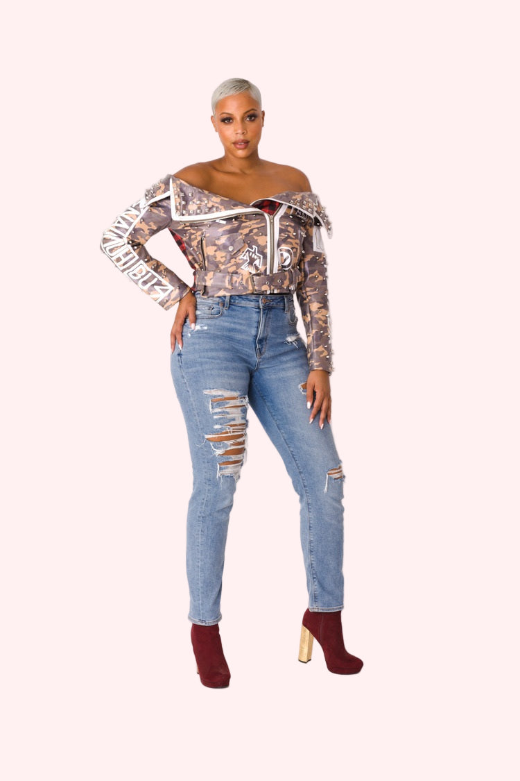 Model wearing camo leather jacket facing forward with hands relaxed by sides