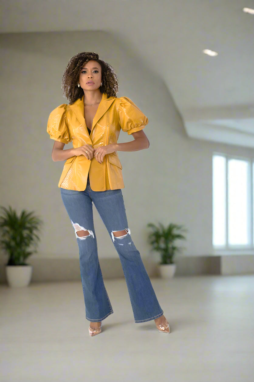 Forward walking view of mustard faux leather puff sleeve jacket – For Her NYC