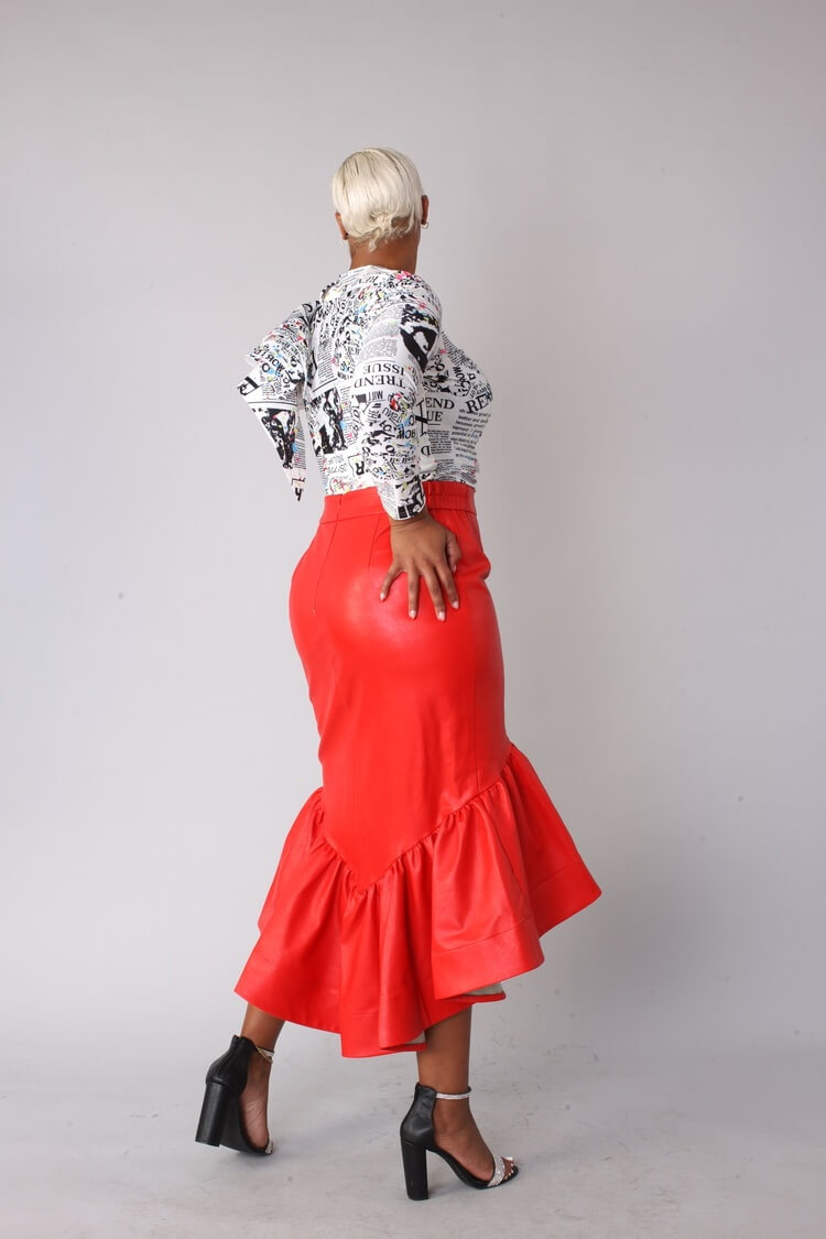 Red faux leather ruffle midi skirt angled back walking pose.