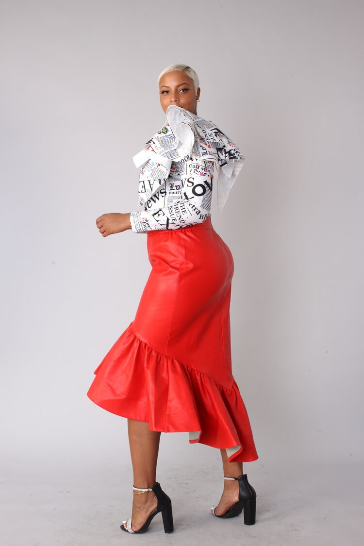 Red faux leather ruffle midi skirt shown walking forward.