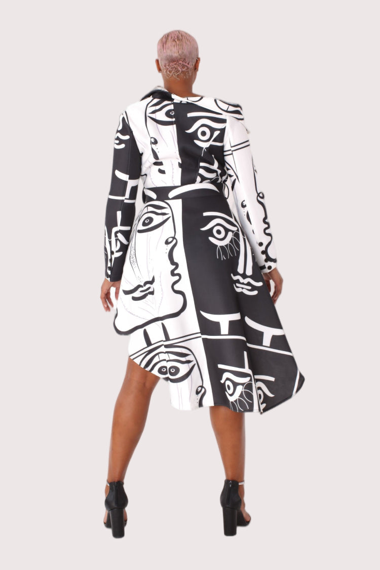 Model wearing long scuba abstraction print belted jacket in black and white, front walking pose showcasing fluid movement, high-contrast abstract design, and fashion-forward outerwear styling by For Her NYC