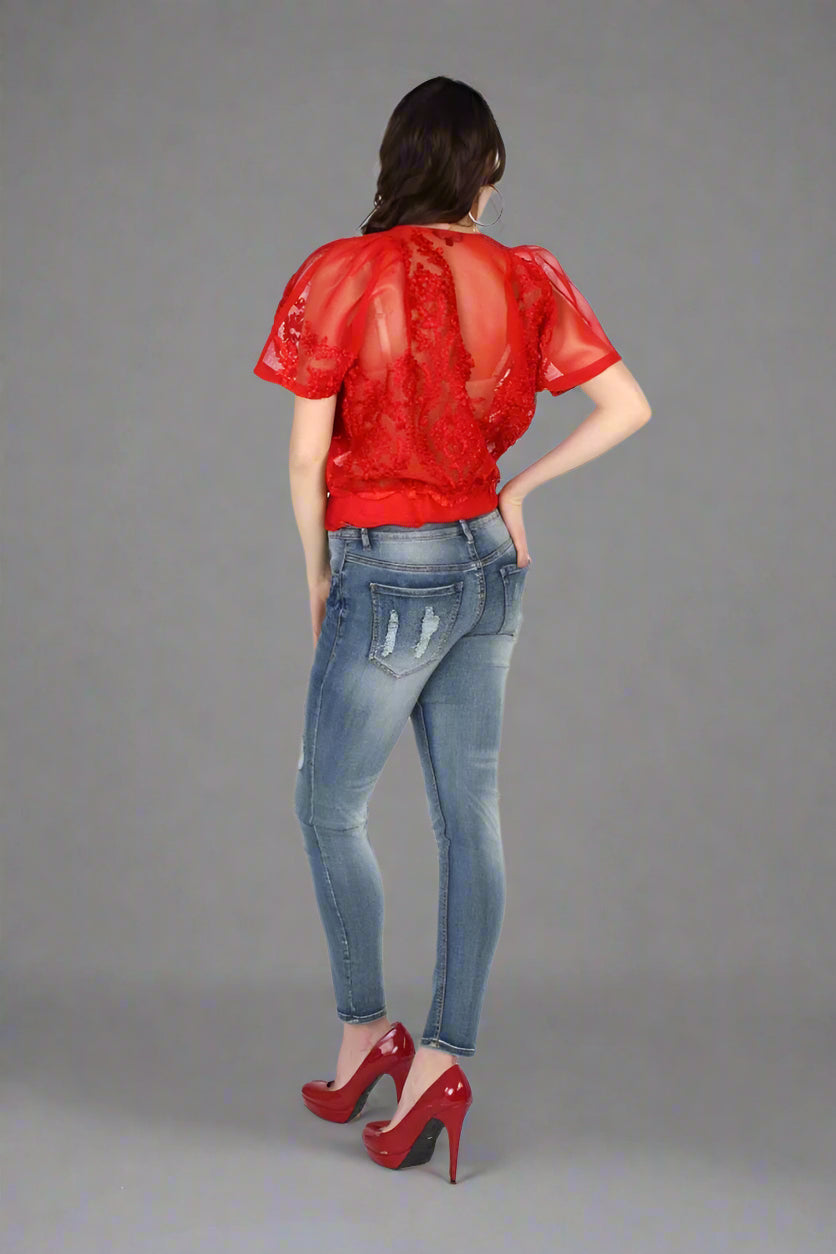 Red mesh bomber jacket back view highlighting sheer mesh detail and relaxed silhouette.