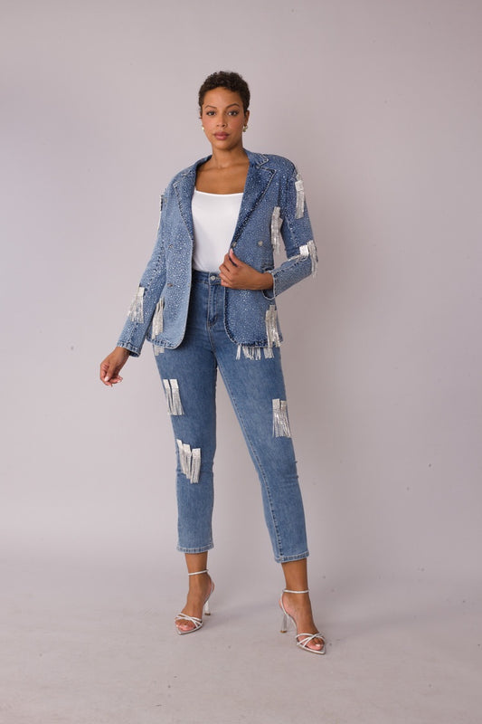 Model wearing the denim metallic fringe cropped jeans styled with matching jacket, standing front facing to showcase silver chain fringe detailing by For Her NYC