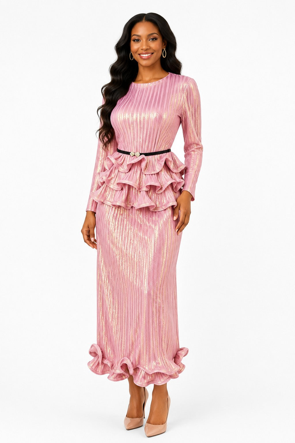 Model wearing the Pink Metallic Ruffle Pleated Skirt Set featuring a shimmering long-sleeve top, dramatic layered ruffle peplum, embellished belt, and flowing pleated midi skirt by For Her NYC.