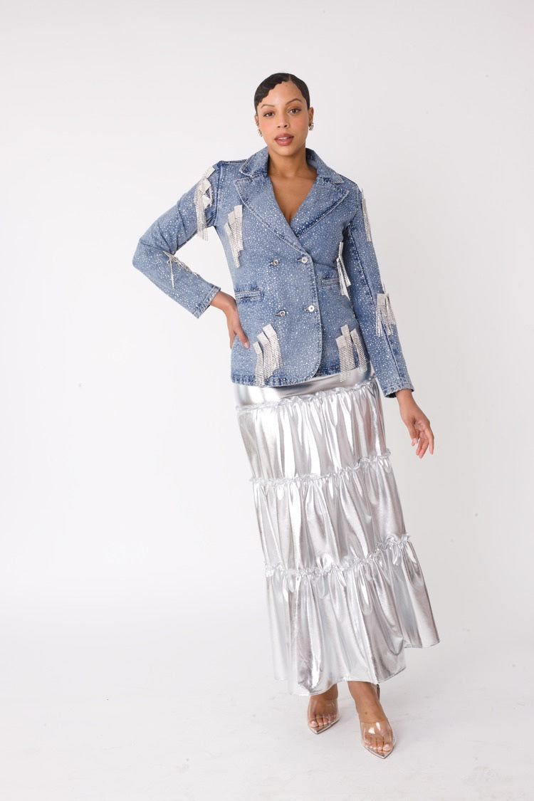 Model wearing the fringe-cropped-denim_jacket with silver metallic tiered maxi skirt standing front facing, showcasing lustrous finish and dramatic tiered silhouette by For Her NYC
