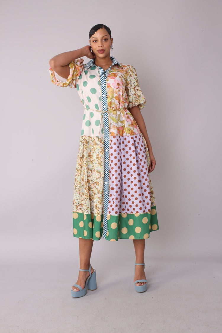 Model wearing the multi print mixed print midi dress standing front facing, showcasing playful mix of florals, polka dots, and stripes with puff sleeves by For Her NY