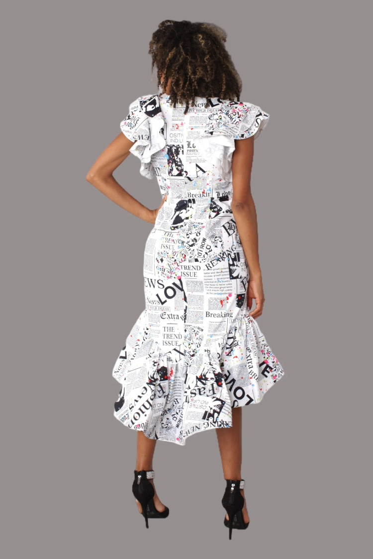 White newspaper print ruffle midi dress shown from the back with ruffled hem