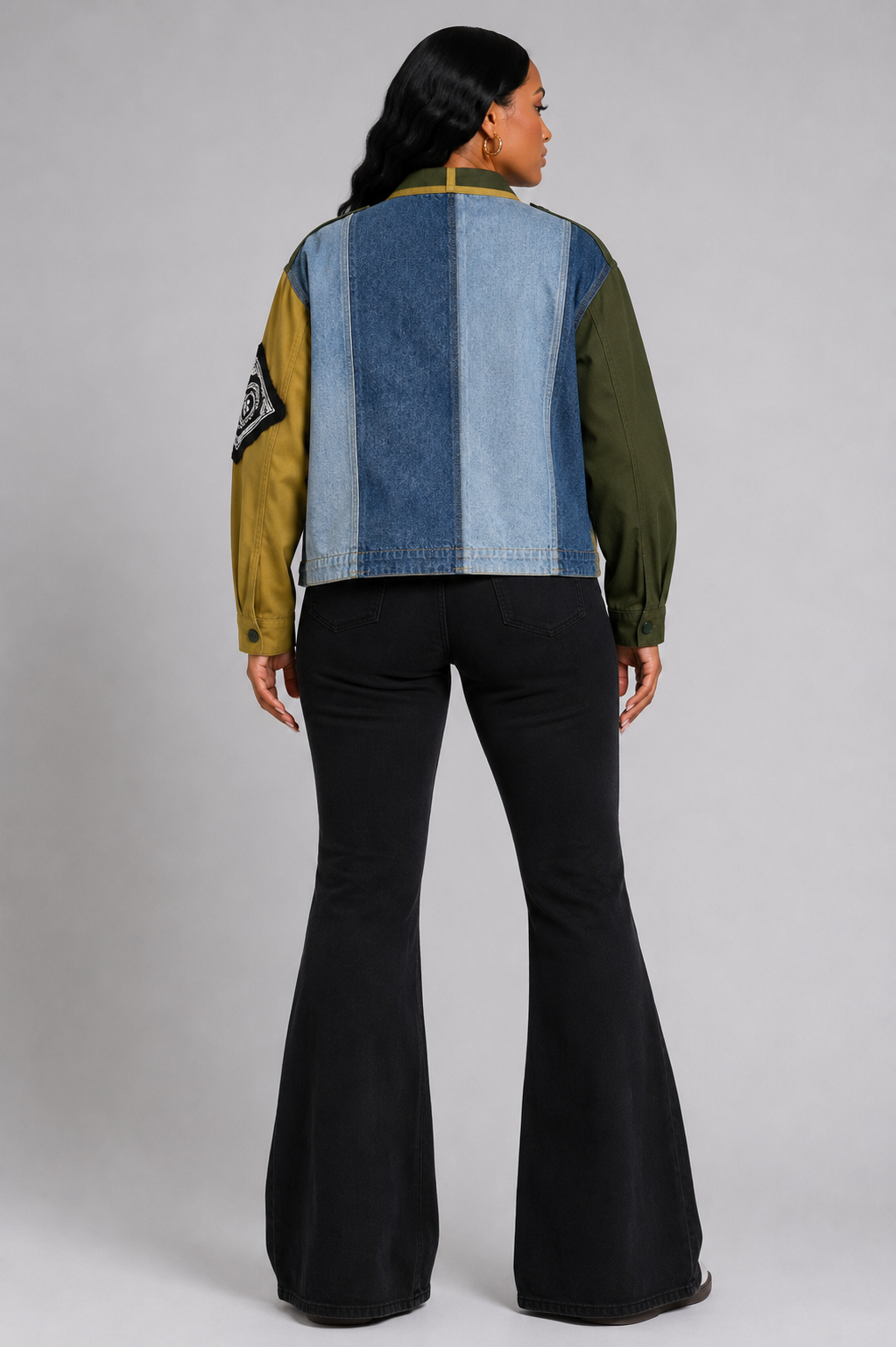 Army green patchwork utility woven jacket with mixed patch detailing and soft woven fabric, seated lifestyle view by For Her NYC