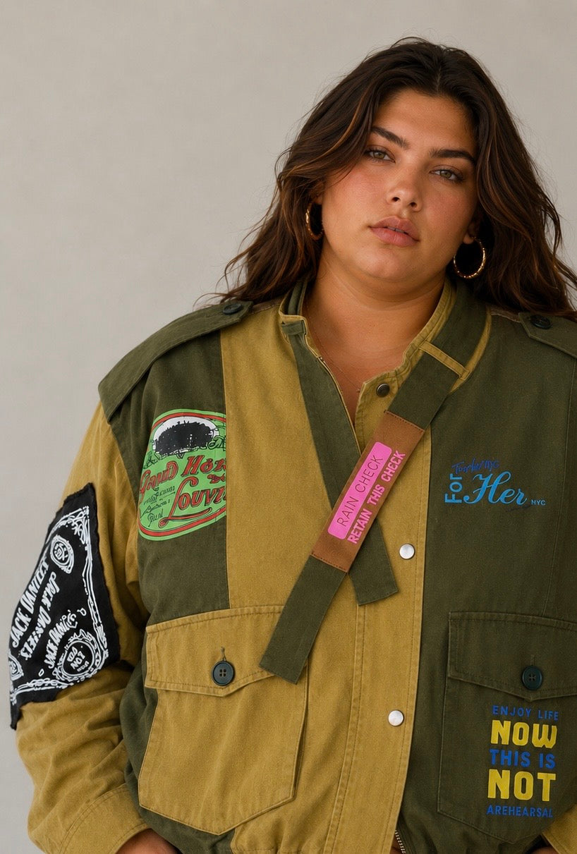 Army green patchwork utility woven jacket with mixed patch detailing and soft woven fabric, seated lifestyle view by For Her NYC
