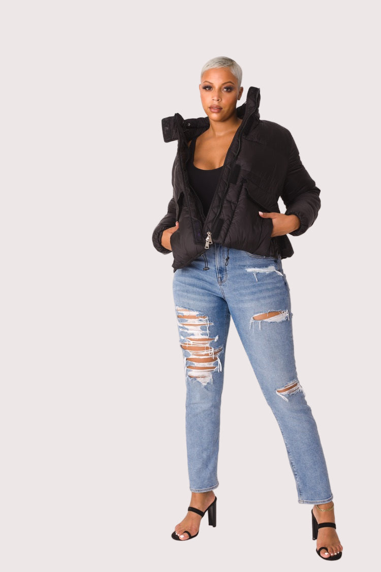 Model wearing black plush puffer jacket, front view highlighting padded construction, oversized fit, and full faux fur texture by For Her NYC