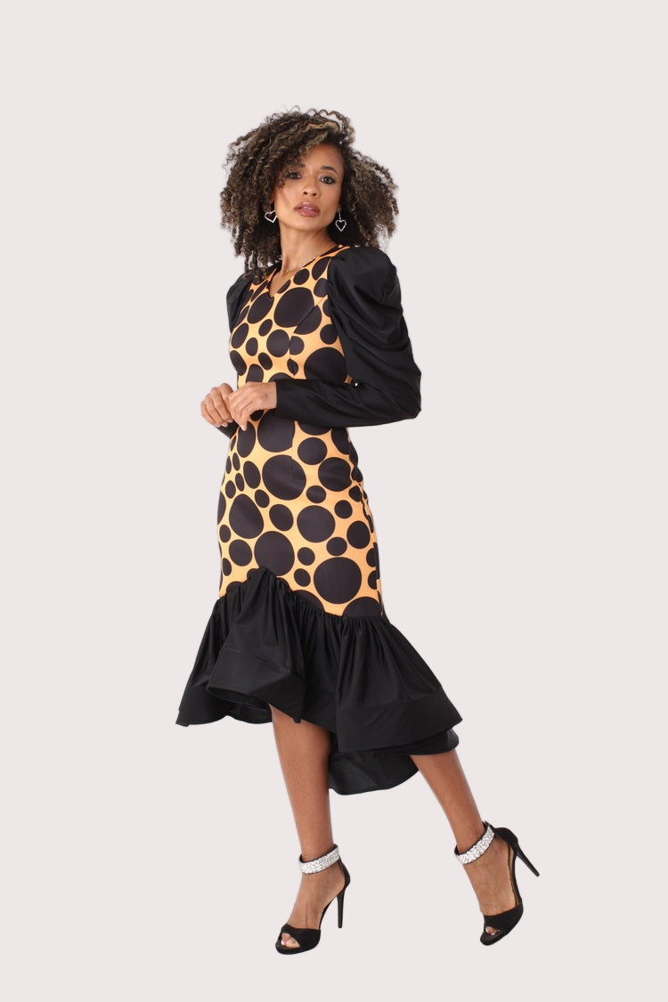 Black and mustard polka dot high-low dress with puff sleeves shown in an angled side pose, emphasizing the high-low hemline and silhouette, formal statement dress by For Her NYC