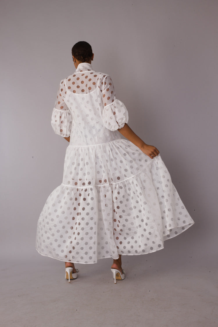 White polka dot tiered maxi dress shown from the back highlighting sheer tiers and fit, For Her NYC