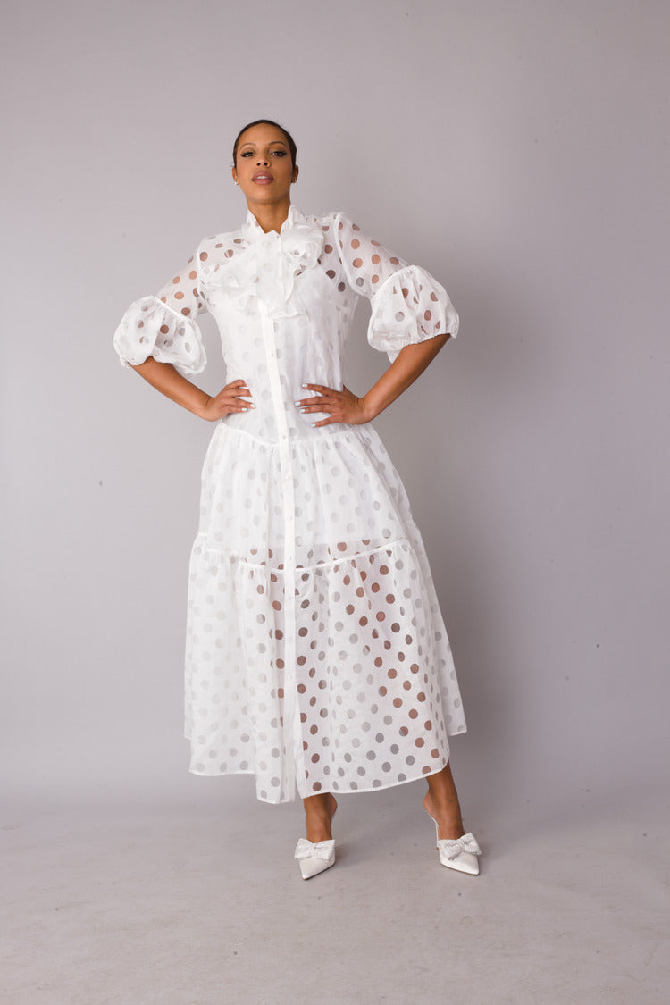 White polka dot tiered maxi dress shown with hands on hips pose highlighting tiered silhouette, For Her NYC